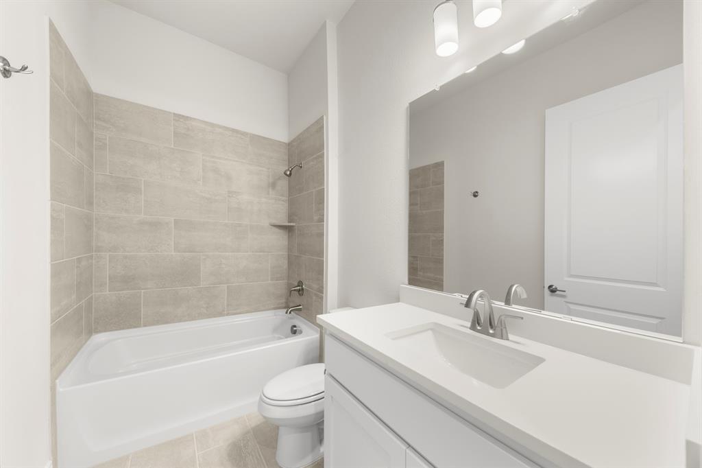 1201 Century Tree Lane Anna, TX 75409 - Photo 4 of 26 a bathroom with a bathtub shower sink vanity mirror and toilet