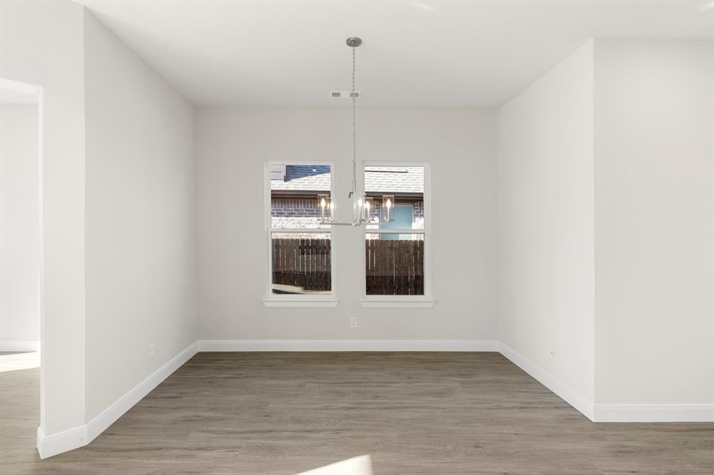 1201 Century Tree Lane Anna, TX 75409 - Photo 10 of 26 a view of an empty room with wooden floor and window