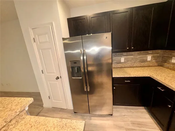 a kitchen with a sink and refrigerator