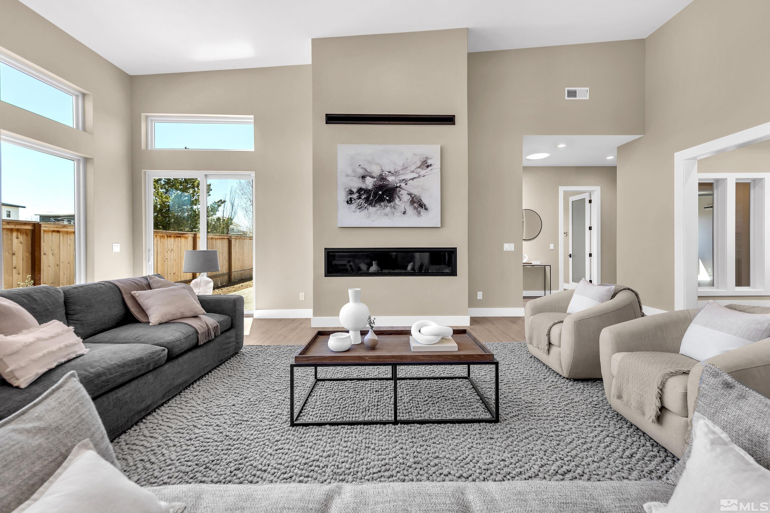 724 Canter Way Reno, NV 89511 - Photo 11 of 40 a living room with furniture a rug and a large window