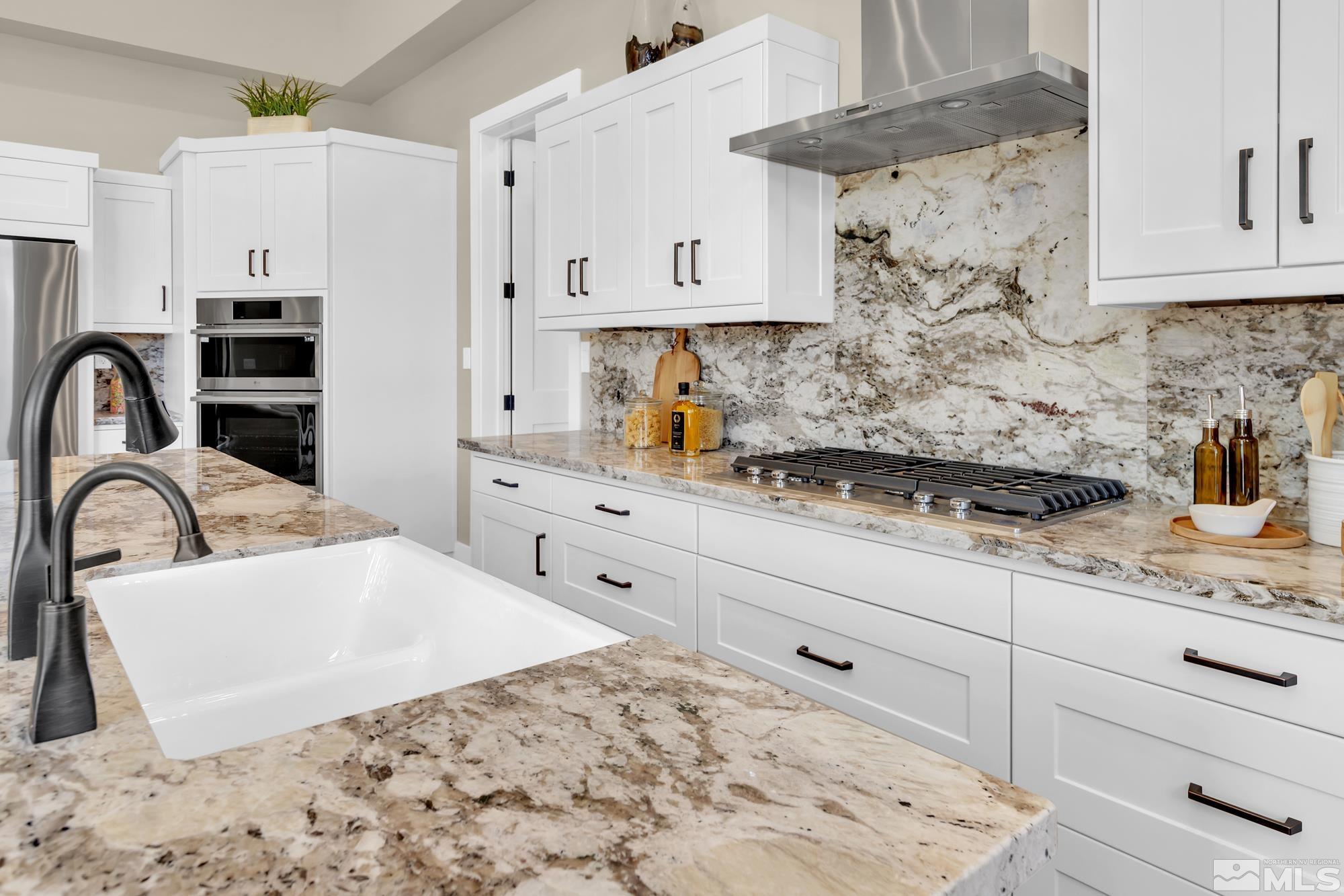 724 Canter Way Reno, NV 89511 - Photo 15 of 40 a kitchen with stainless steel appliances kitchen island granite countertop a sink a stove and cabinets