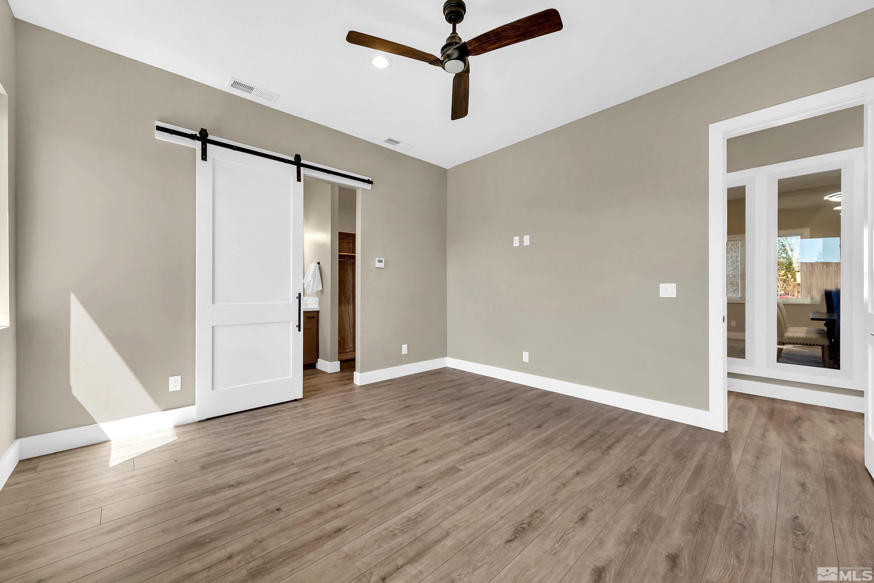 724 Canter Way Reno, NV 89511 - Photo 20 of 40 a view of a room with wooden floor and white walls