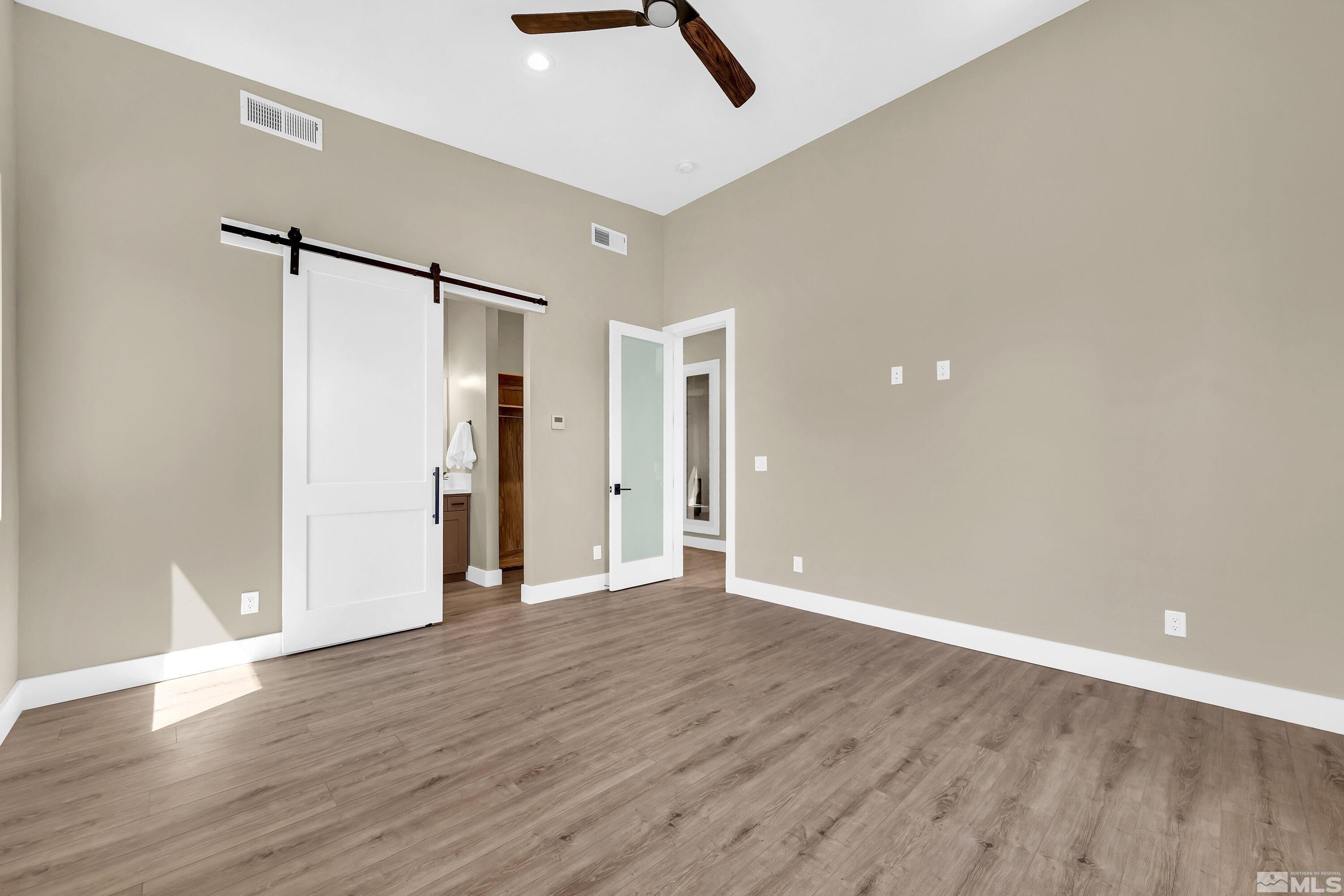 724 Canter Way Reno, NV 89511 - Photo 21 of 40 a view of an empty room with wooden floor