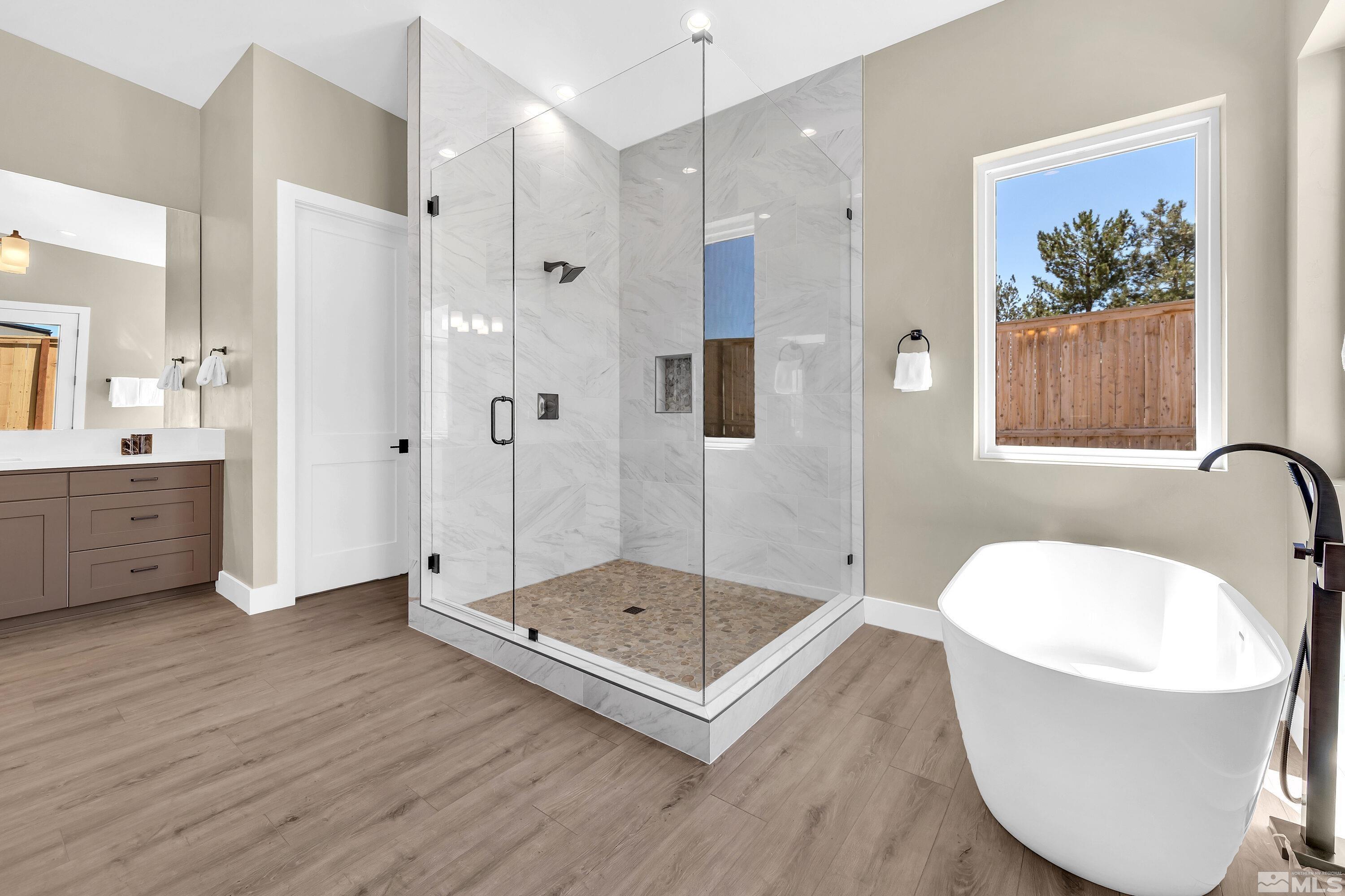 724 Canter Way Reno, NV 89511 - Photo 26 of 40 a bathroom with a tub sink shower and mirror