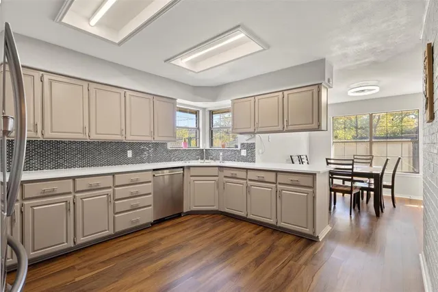 a kitchen with sink cabinets and dining table chair