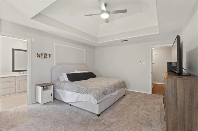 a bedroom with a bed and a television