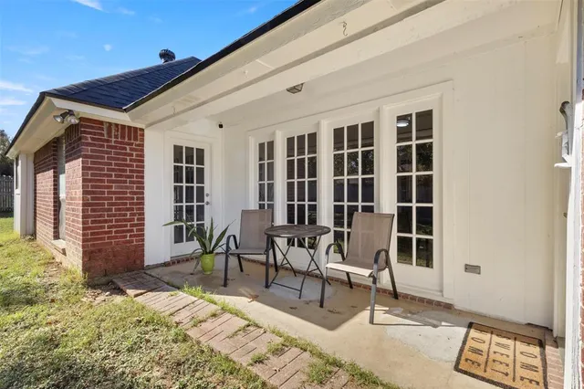 a building outdoor space with patio furniture and potted plants