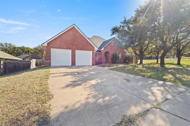 a view of a house with a yard and pathway