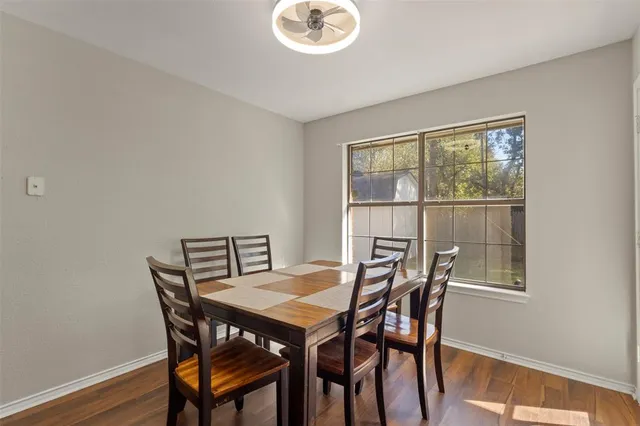 a view of a dining room with furniture and a window