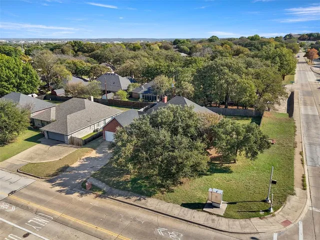 an aerial view of residential houses with outdoor space and street view