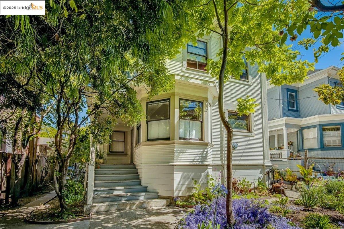 a front view of a house with a garden