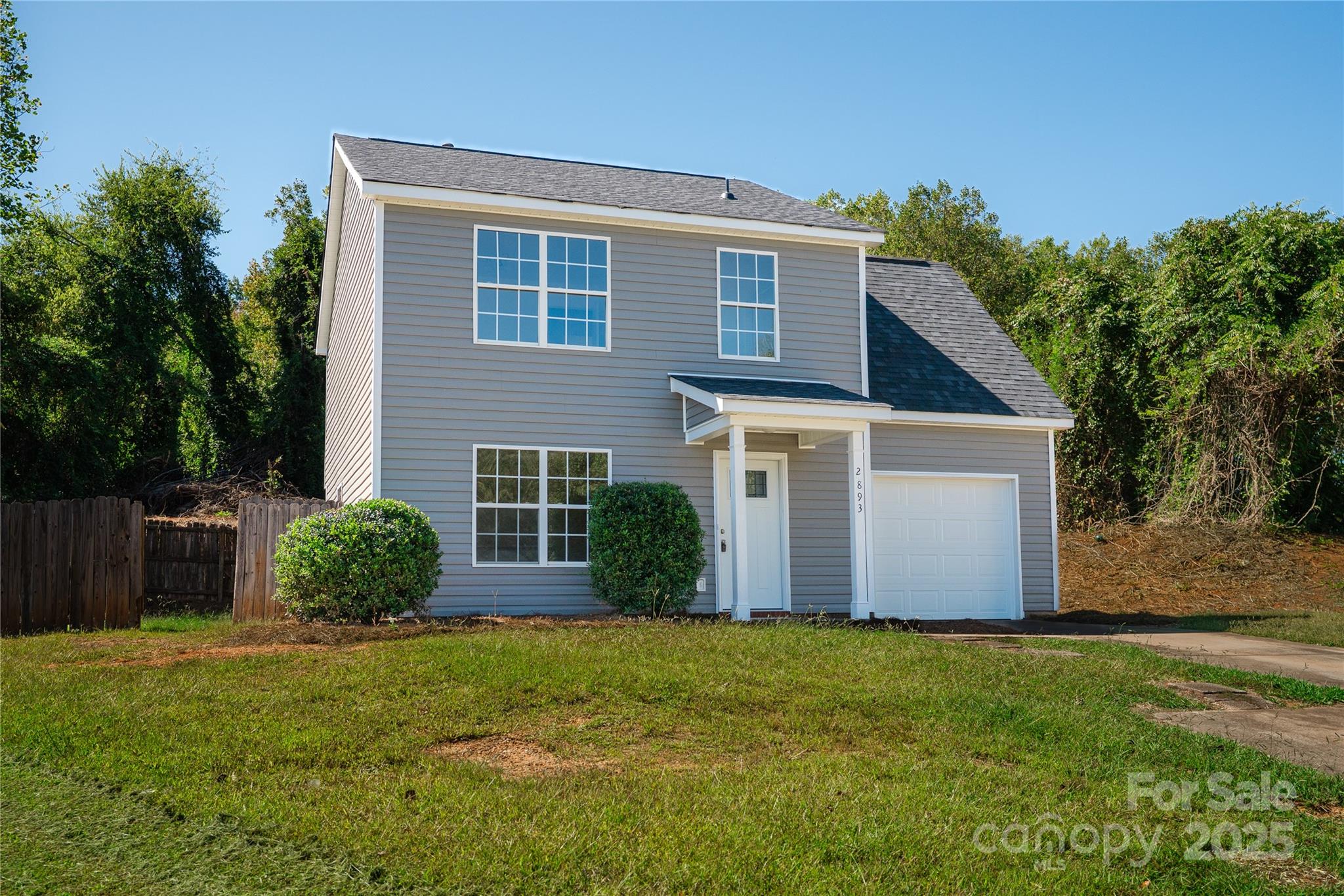 2893 Signal Court Southwest Concord, NC 28025 - Photo 1 of 32 a front view of a house with a yard