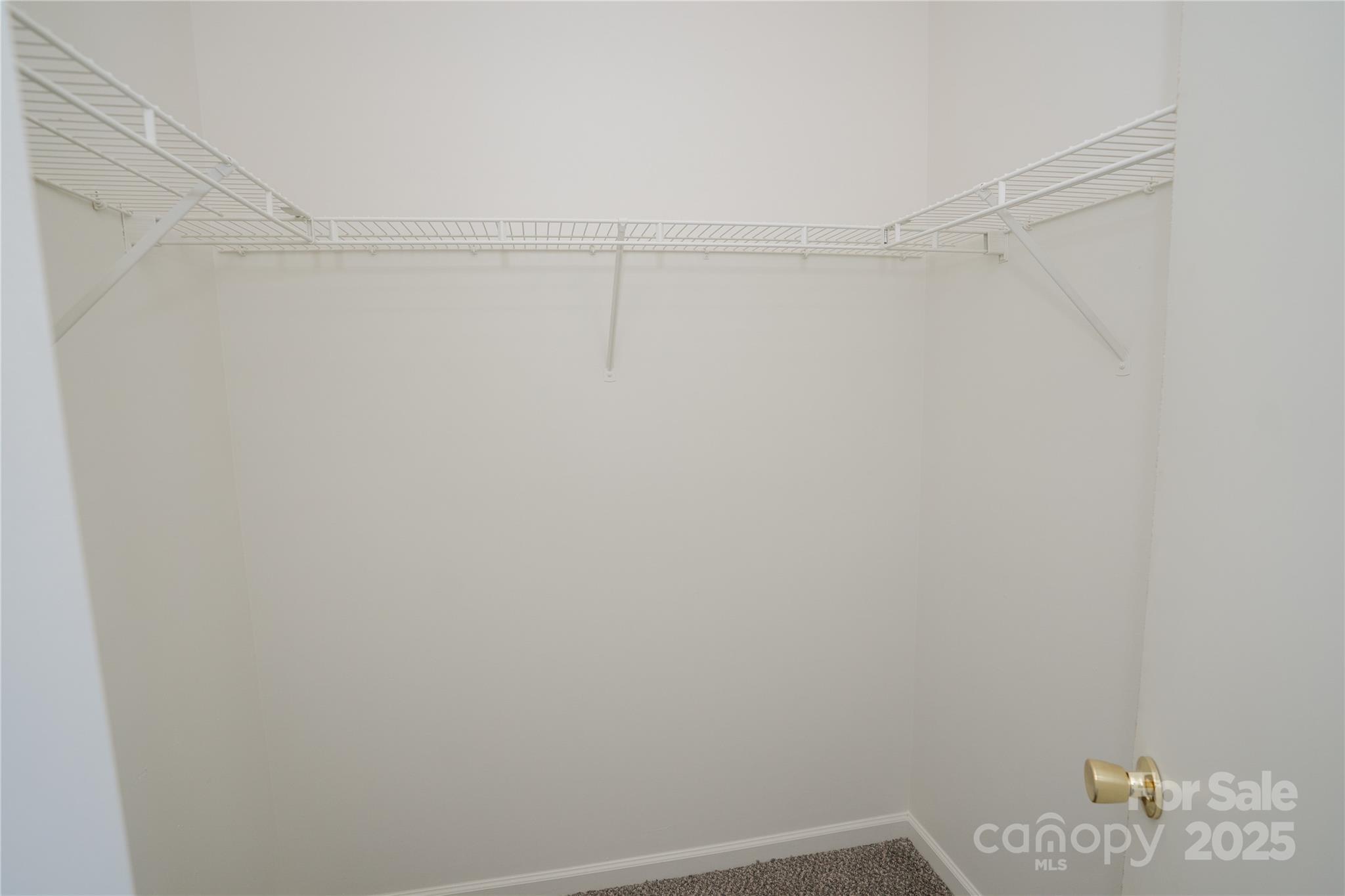 2893 Signal Court Southwest Concord, NC 28025 - Photo 18 of 32 a view of a room with racks on the wall