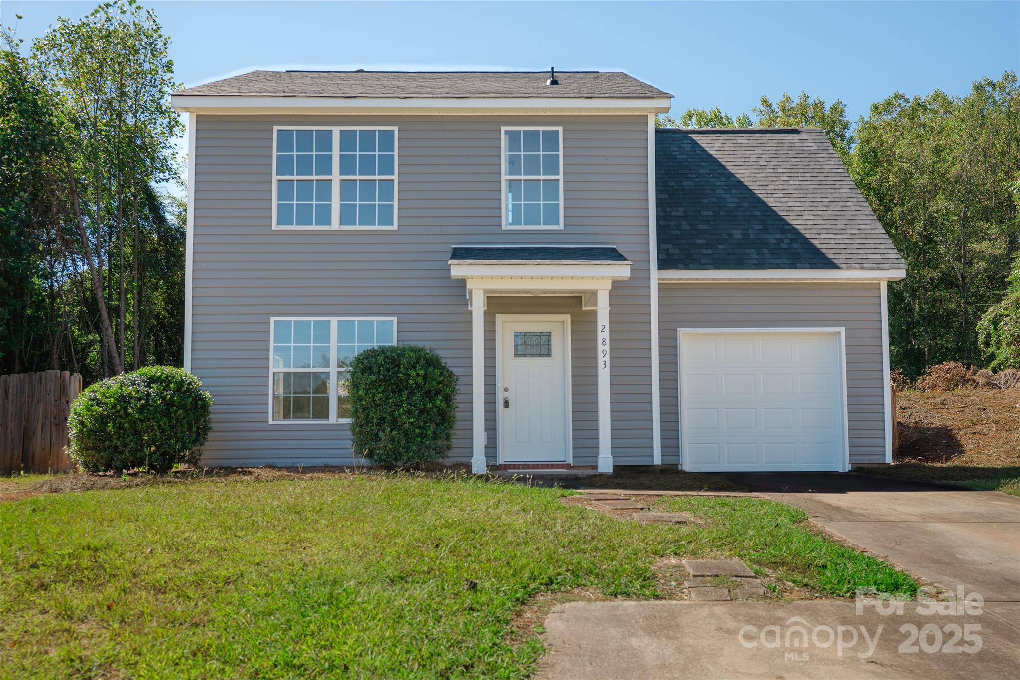 2893 Signal Court Southwest Concord, NC 28025 - Photo 2 of 32 a front view of a house with a yard