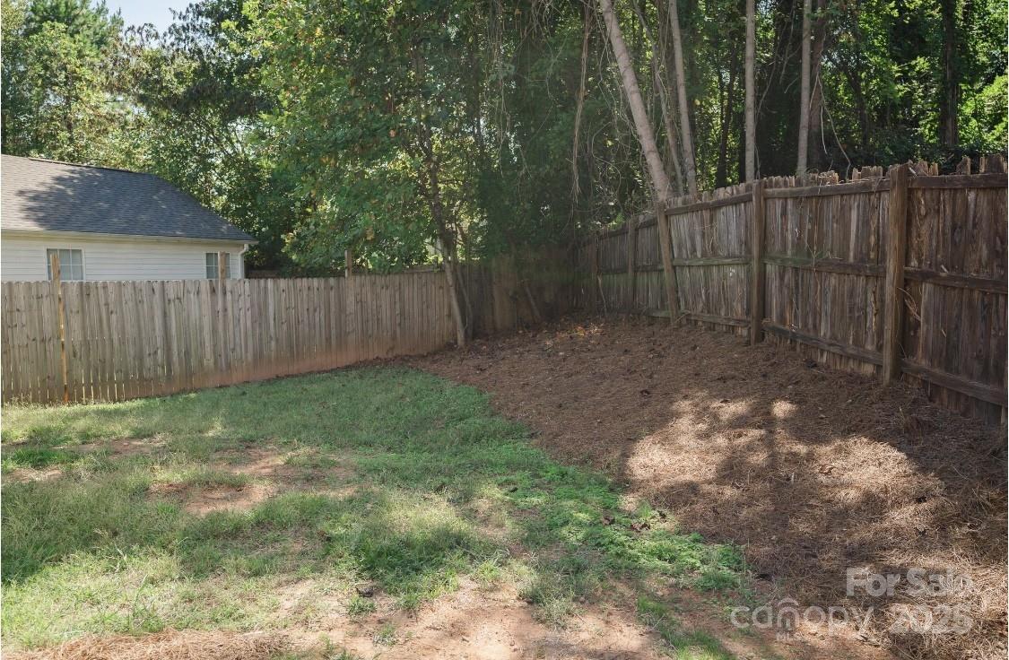 2893 Signal Court Southwest Concord, NC 28025 - Photo 29 of 32 a backyard of a house with lots of green space