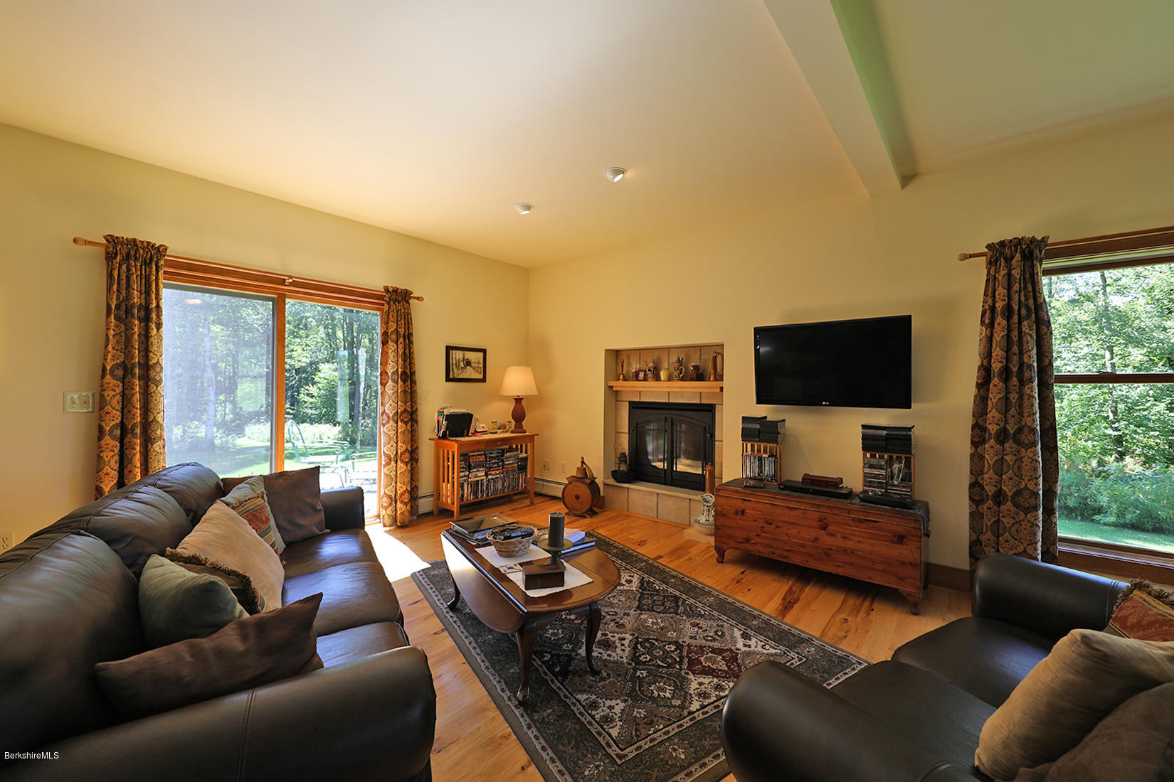 11 Stump Road Sandisfield, MA 01255 - Photo 13 of 41 a living room with furniture a flat screen tv and a large window