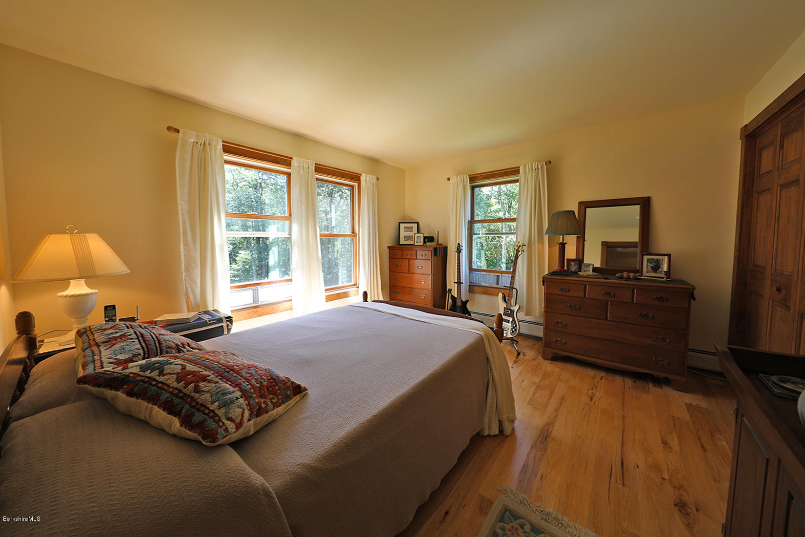 11 Stump Road Sandisfield, MA 01255 - Photo 25 of 41 a bed sitting in a bedroom next to a window with dresser