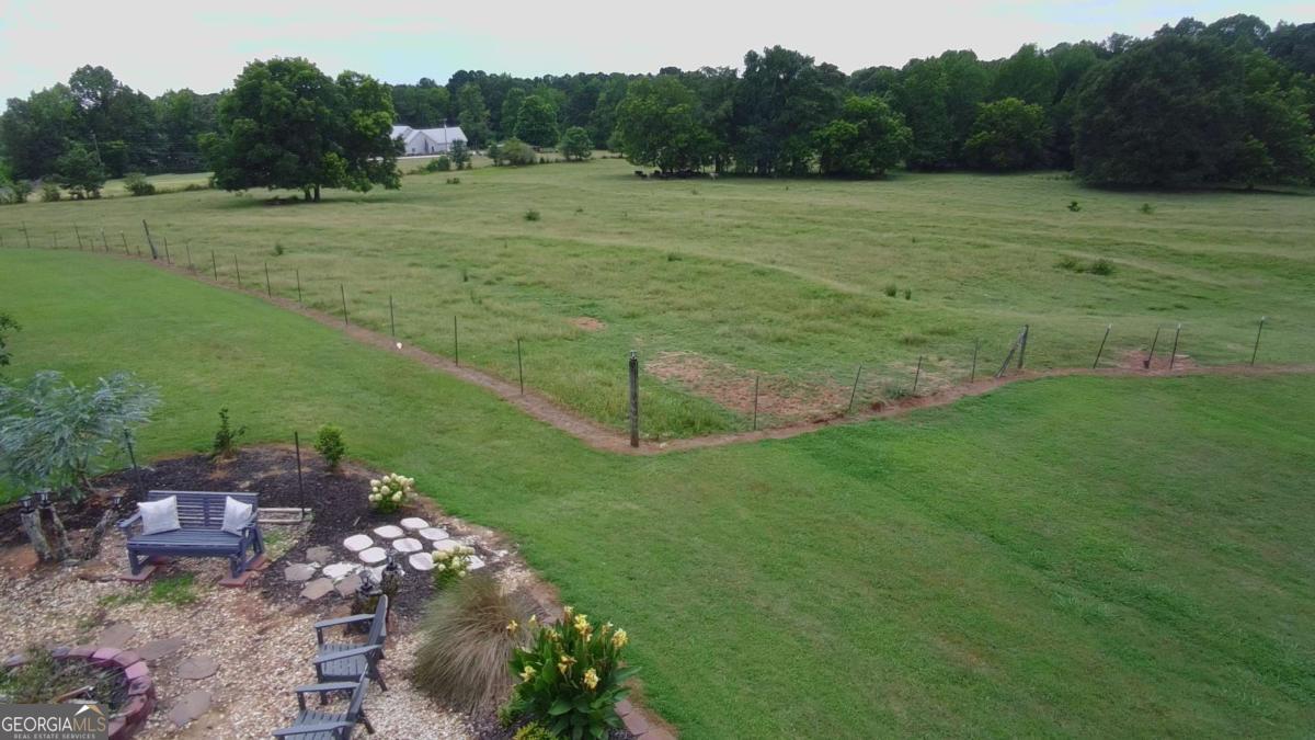 876 Simpson Mill Road Locust Grove, GA 30248 - Photo 14 of 51 a view of a grassy area with an trees