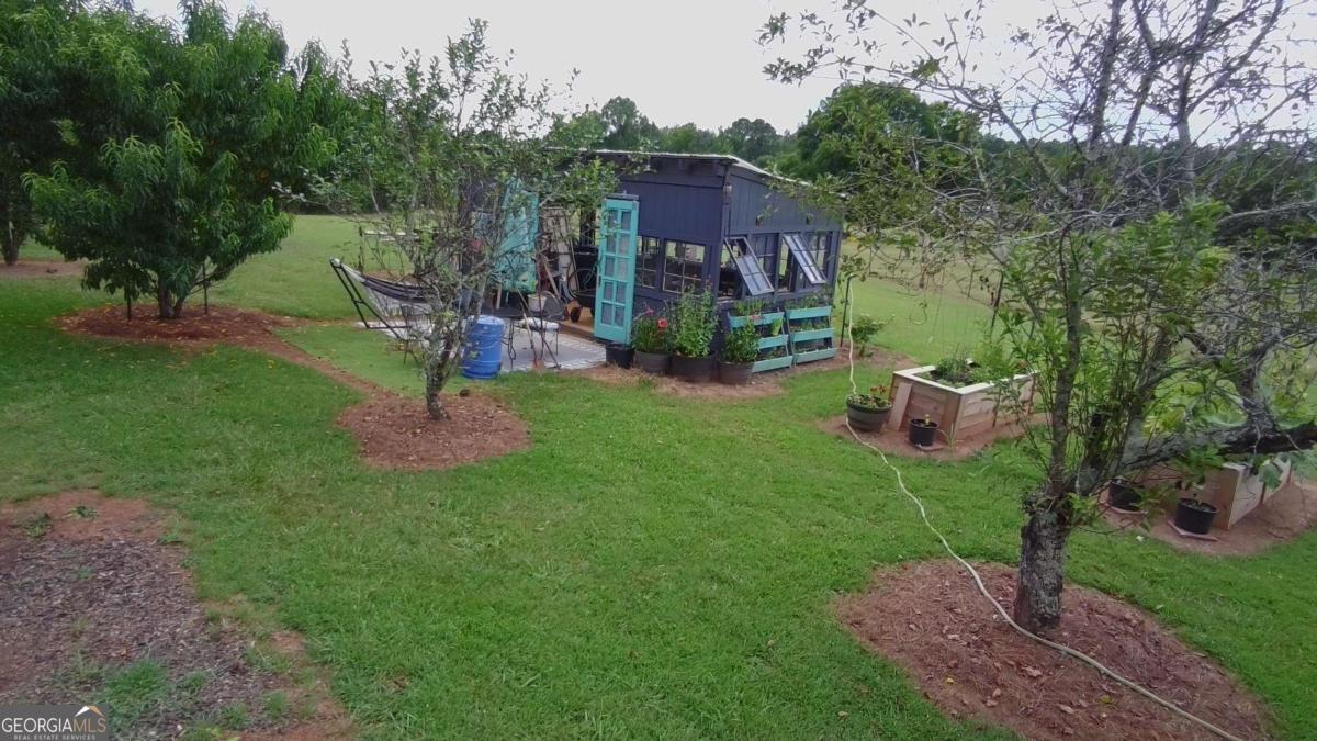 876 Simpson Mill Road Locust Grove, GA 30248 - Photo 24 of 51 a view of a chairs in a backyard