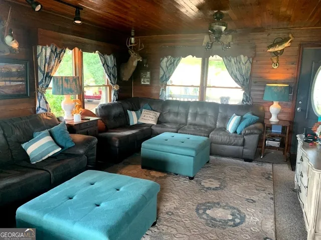 a room with furniture pool table and flat screen tv