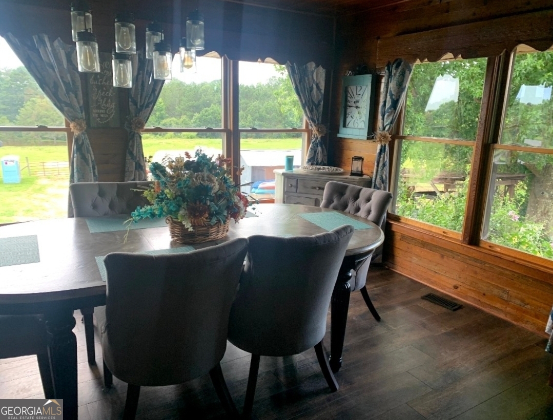 876 Simpson Mill Road Locust Grove, GA 30248 - Photo 5 of 51 a dining room with furniture window and wooden floor