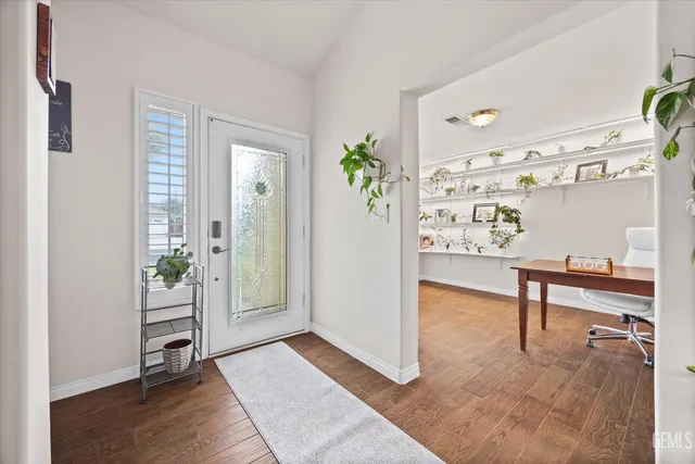 a view of an entryway with wooden floor and windows