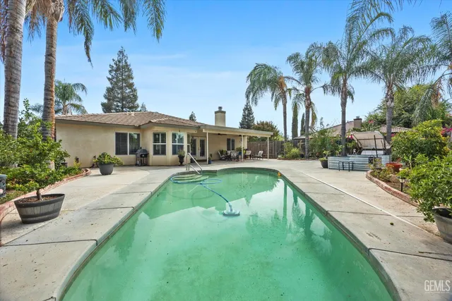 a house with palm tree in front of it