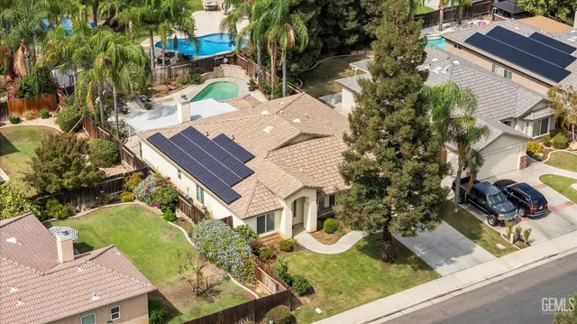 an aerial view of a house with garden space and street view