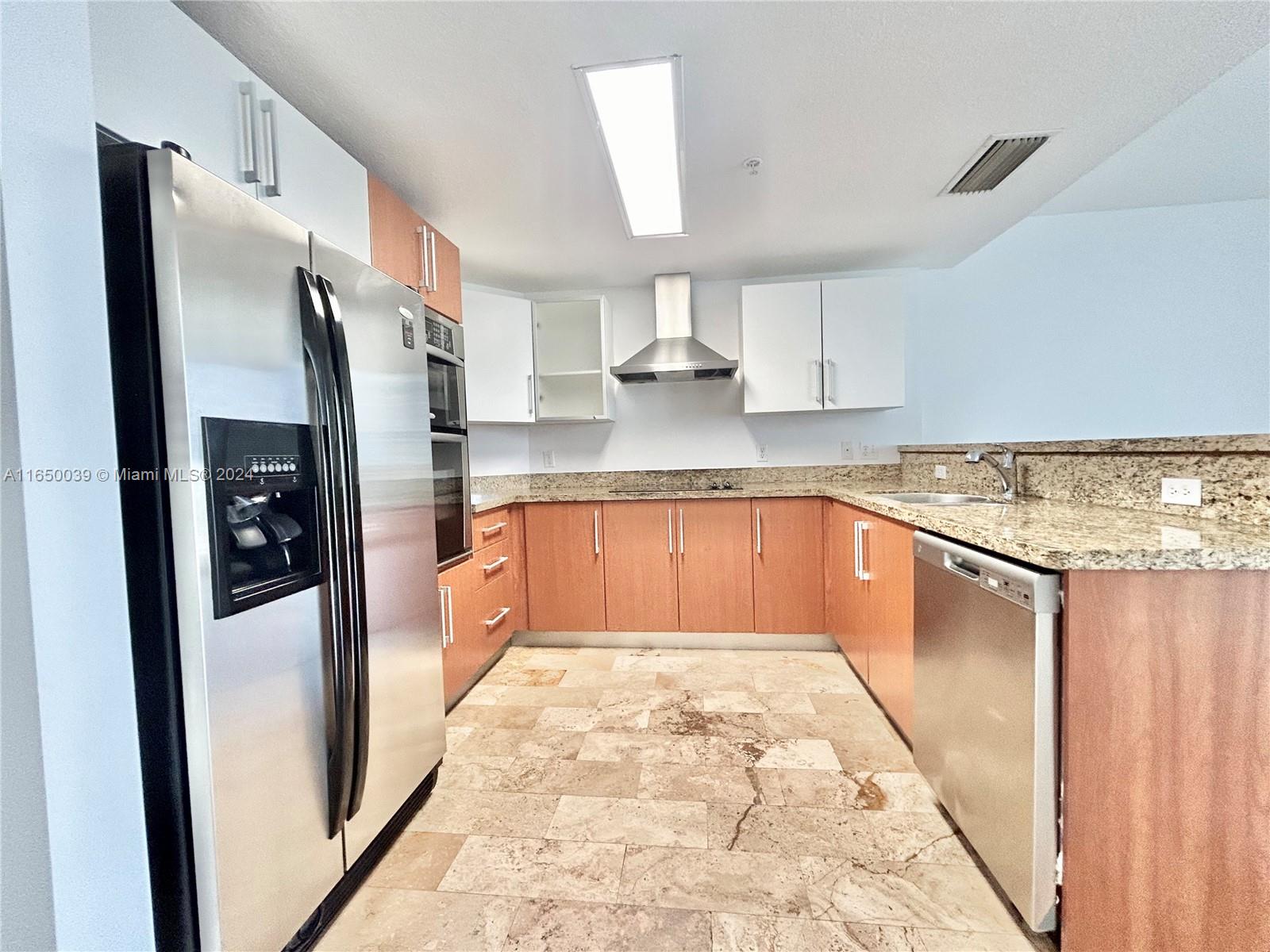 170 Southeast 14th Street, Unit 2906 Miami, FL 33131 - Photo 2 of 31 a kitchen with stainless steel appliances granite countertop a refrigerator and a sink