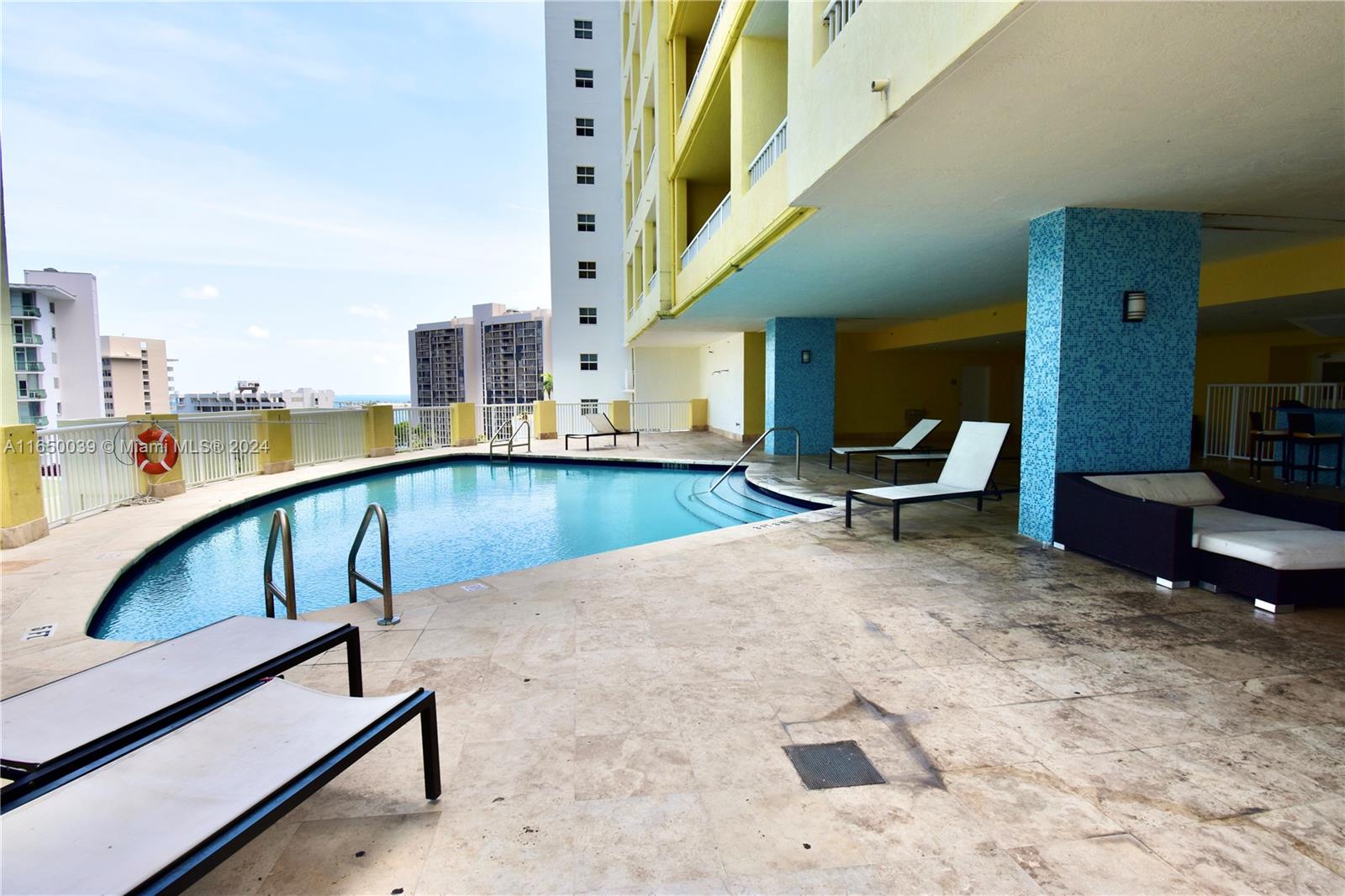 170 Southeast 14th Street, Unit 2906 Miami, FL 33131 - Photo 30 of 31 a view of a swimming pool with lounge chair