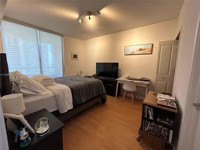 a bedroom with a bed and a tv