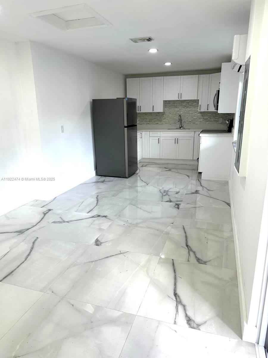 26205 Southwest 133rd Court, Unit 2 Homestead, FL 33032 - Photo 11 of 17 a view of kitchen with refrigerator sink and cabinets