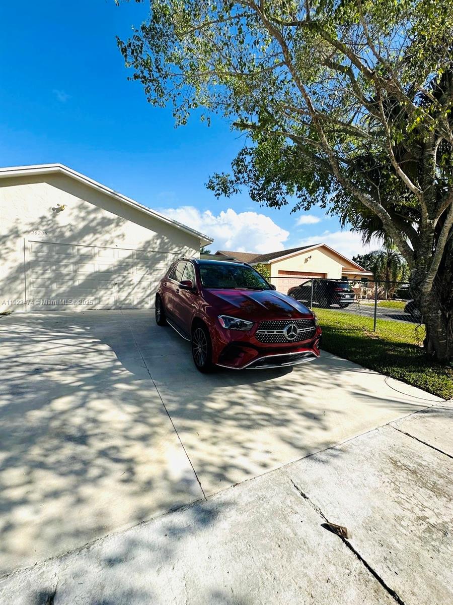 26205 Southwest 133rd Court, Unit 2 Homestead, FL 33032 - Photo 14 of 17 a view of a yard with car parked