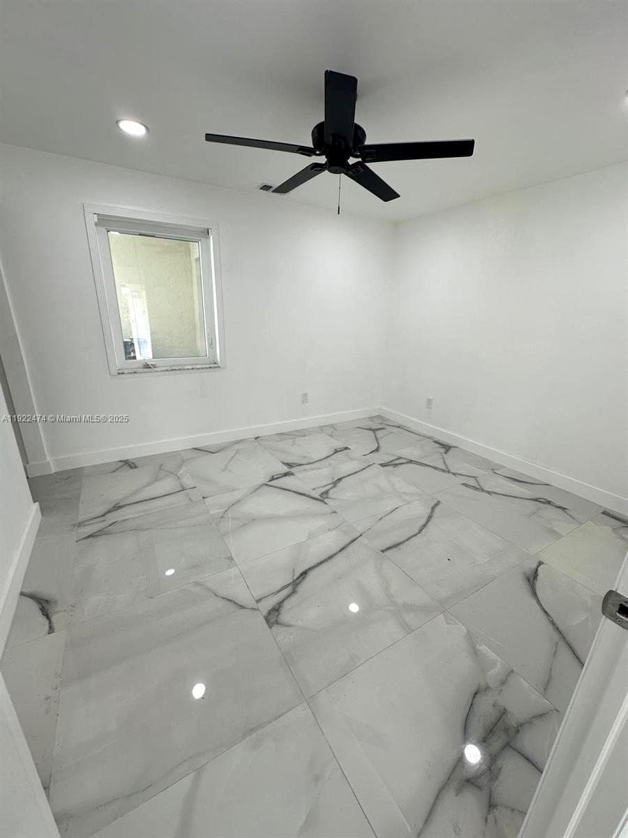 26205 Southwest 133rd Court, Unit 2 Homestead, FL 33032 - Photo 6 of 17 a view of a room with a ceiling fan and window