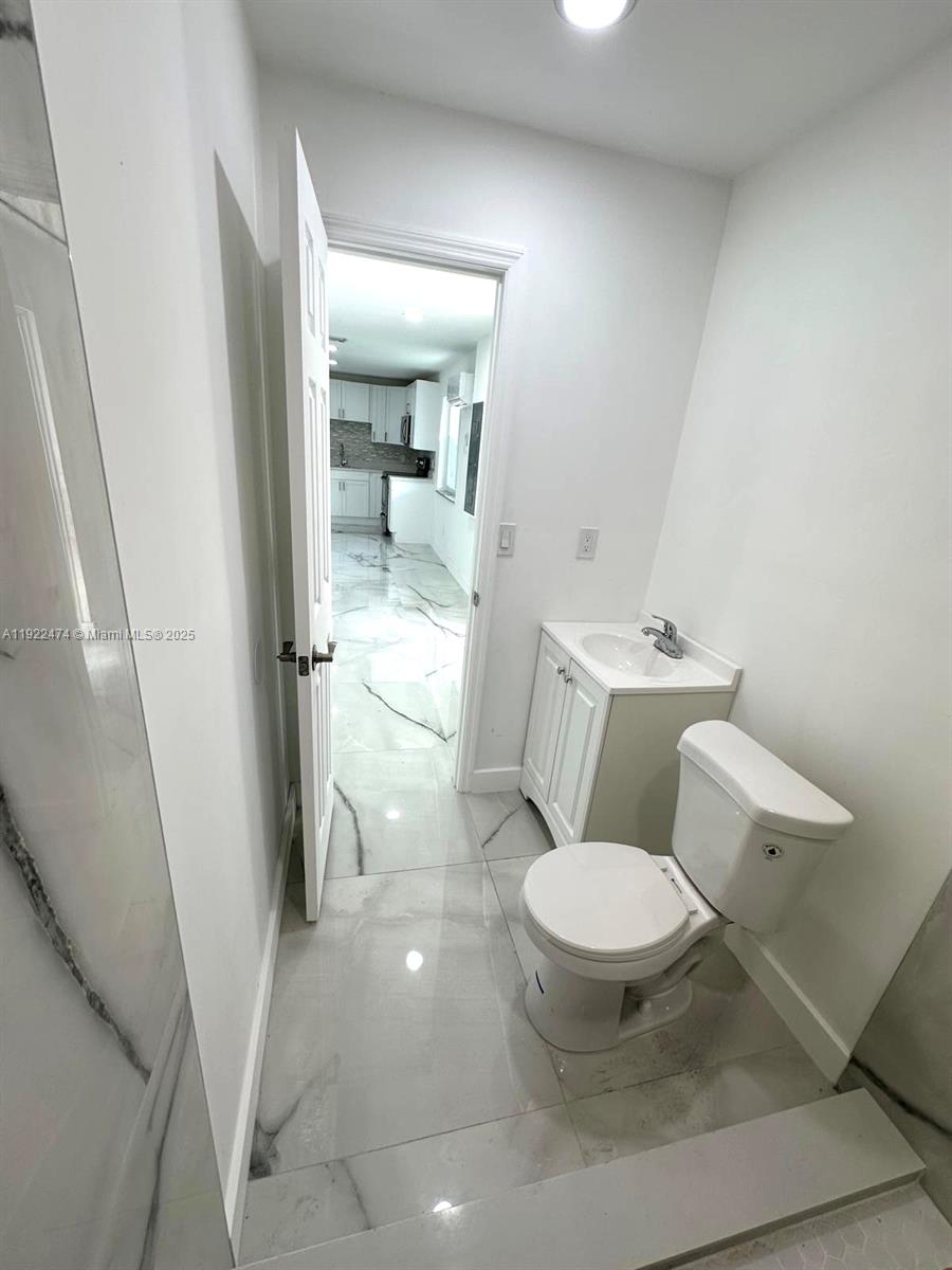 26205 Southwest 133rd Court, Unit 2 Homestead, FL 33032 - Photo 7 of 17 a bathroom with a toilet and a shower