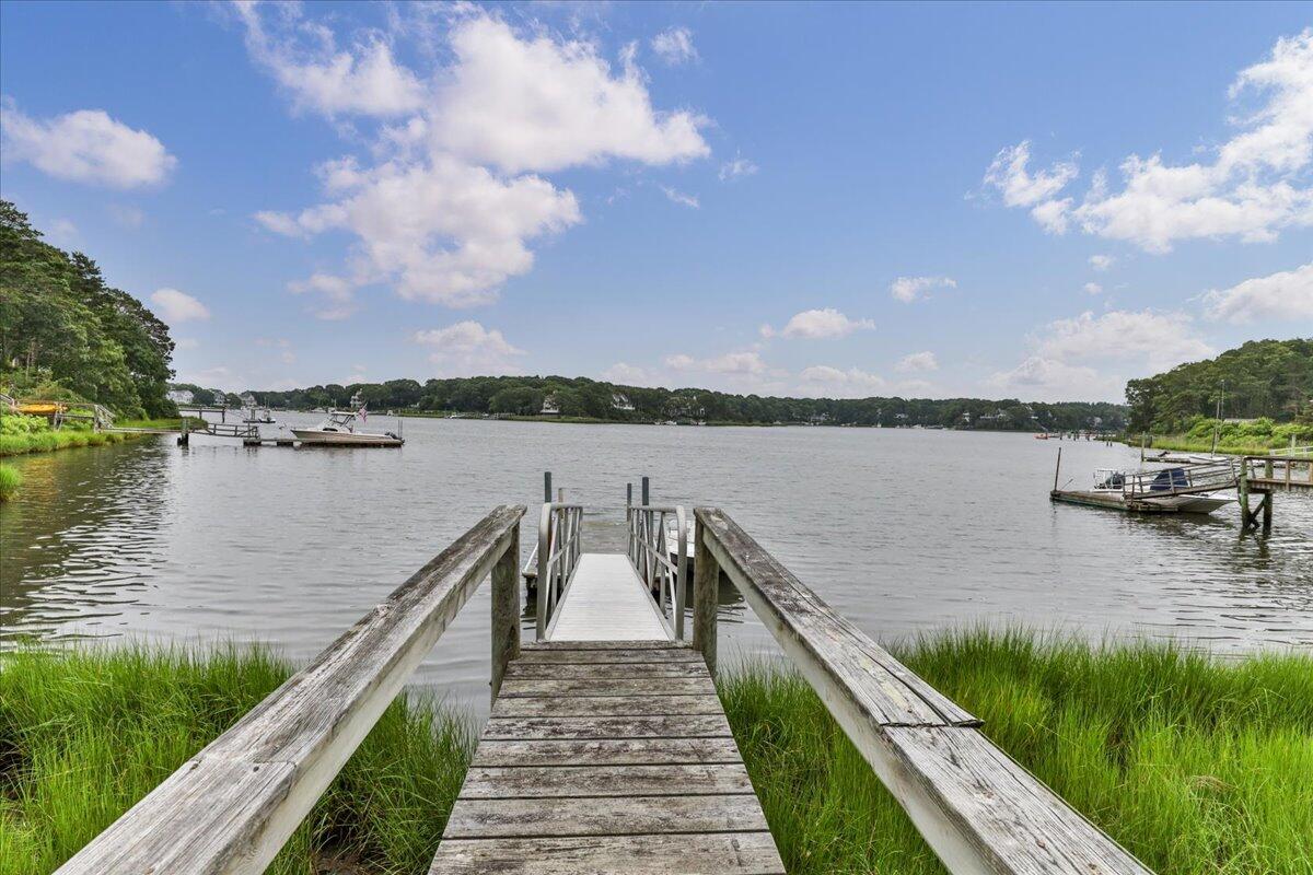 19 Ockway Bay Road Mashpee, MA 02649 - Photo 2 of 79 a view of a lake with houses in the back