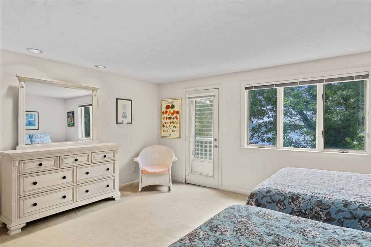 19 Ockway Bay Road Mashpee, MA 02649 - Photo 37 of 79 a spacious bedroom with a bed a table and cabinet