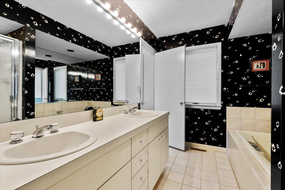 19 Ockway Bay Road Mashpee, MA 02649 - Photo 45 of 79 a bathroom with a sink vanity granite tub and a mirror