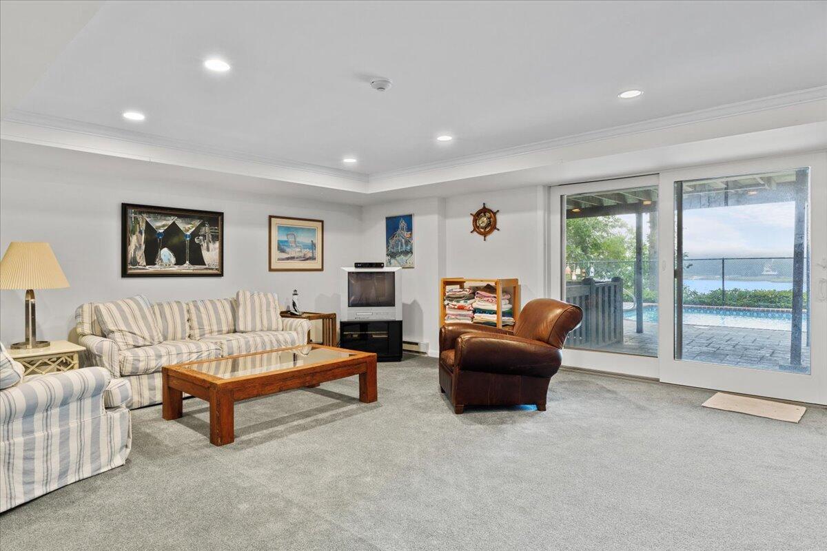 19 Ockway Bay Road Mashpee, MA 02649 - Photo 47 of 79 a living room with furniture and a flat screen tv