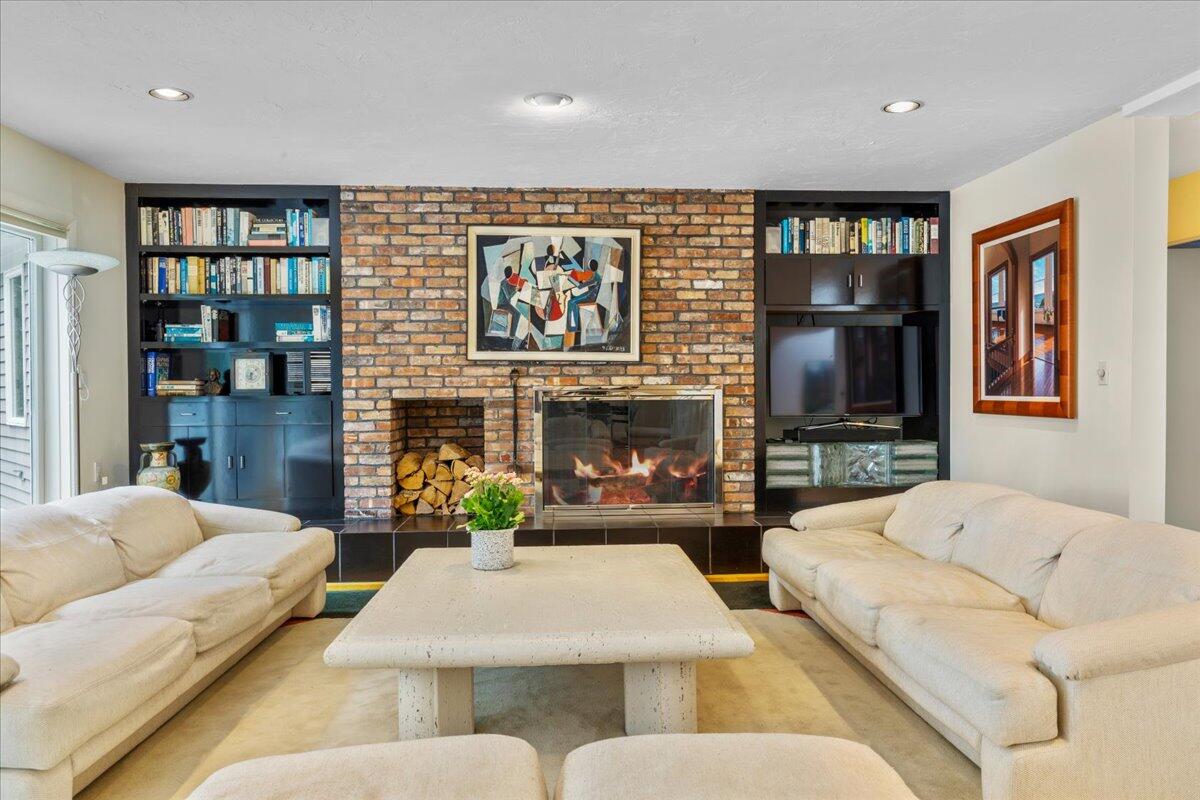 19 Ockway Bay Road Mashpee, MA 02649 - Photo 9 of 79 a living room with fireplace furniture and a flat screen tv