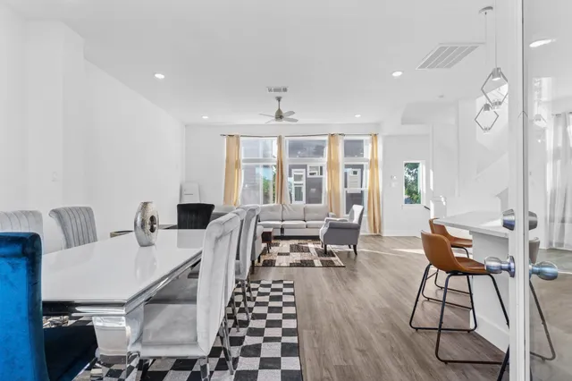 a kitchen with a stove and a wooden floor