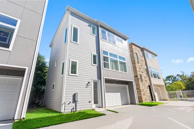 a view of a house with a yard and garage