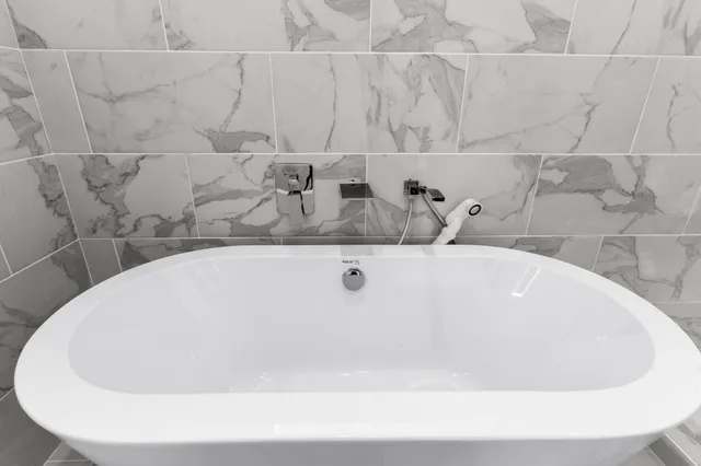a white bath tub sitting in a bathroom
