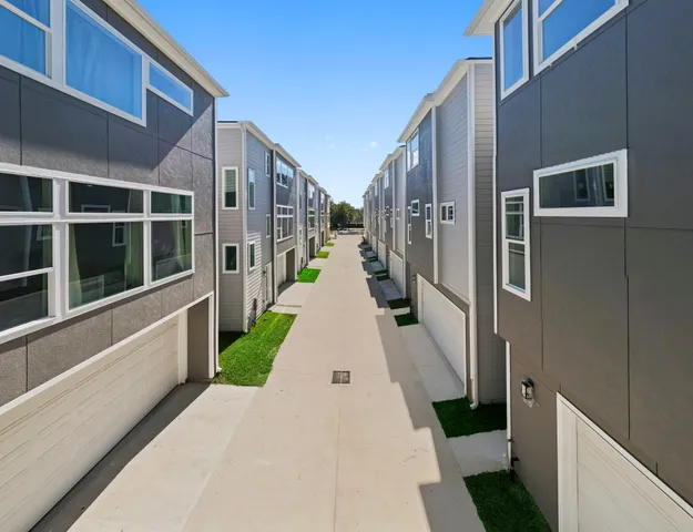 a bathroom with a granite countertop toilet a sink and mirror