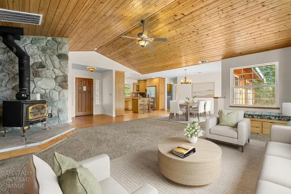 a kitchen with kitchen island granite countertop wooden floors and white stainless steel appliances