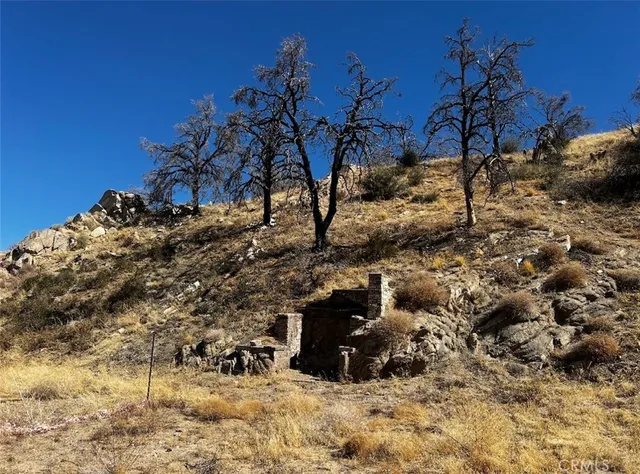 a view of a large building with mountains in the background