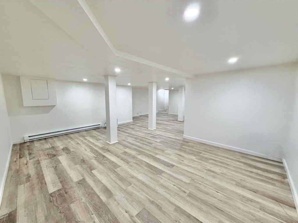 9 Robbins Street Waltham, MA 02453 - Photo 30 of 42 a view of an empty room with wooden floor