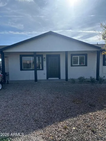 a view of house with yard