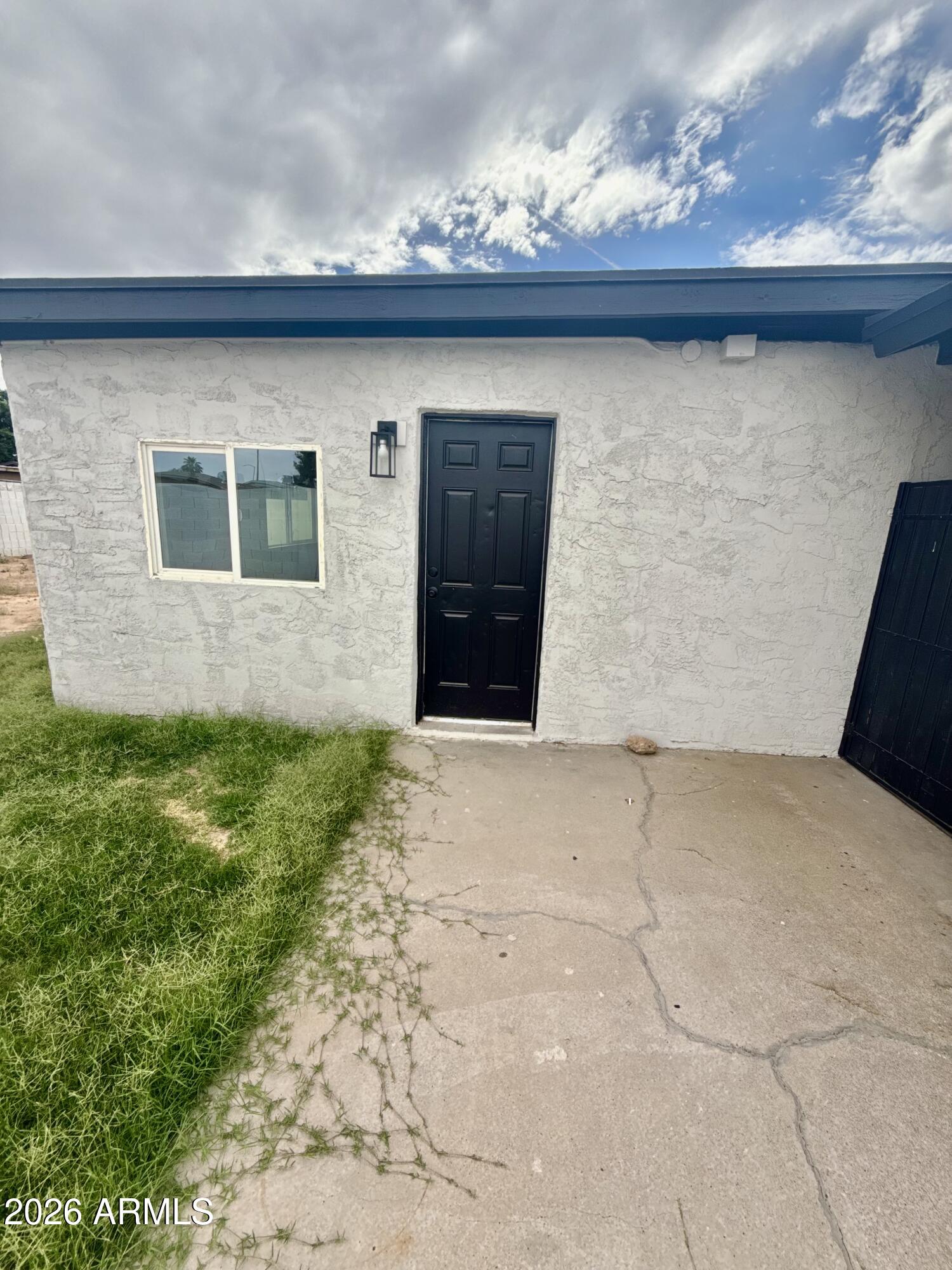 6963 West Rancho Drive Glendale, AZ 85303 - Photo 6 of 14 a front view of a house with a yard and garage