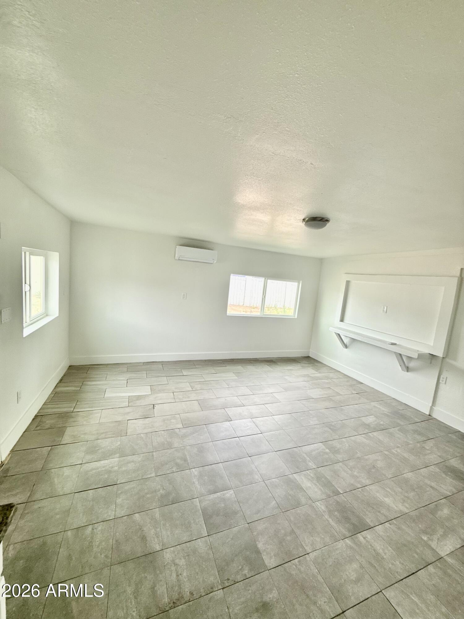 6963 West Rancho Drive Glendale, AZ 85303 - Photo 7 of 14 a view of an empty room and a window